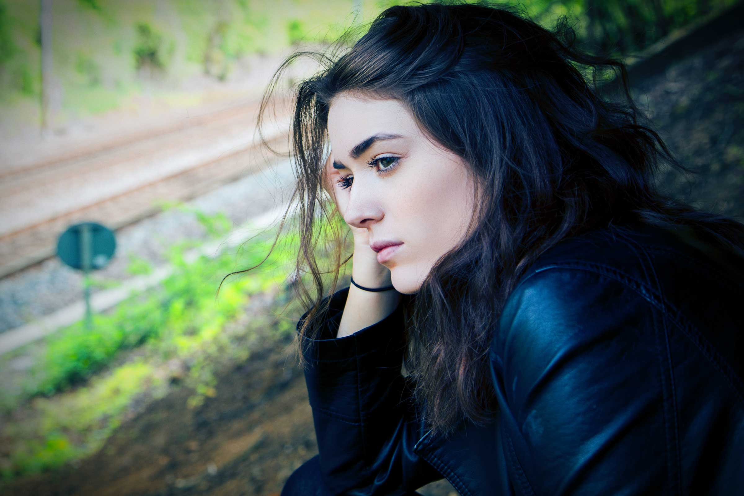 Photo of a young woman looking sad. Photo by Kyle Broad.